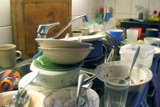 Dishes piled up in a sink