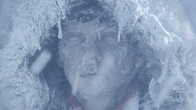 Game of Thrones Gif. Close-up of a frozen man's face in a frozen hood in a snow storm