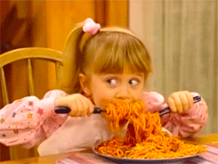 Girl eating large plate of spaghetti