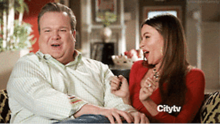 Frame from Modern Family of Cam and Gloria giggling