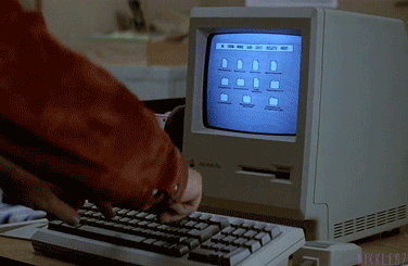 Man typing on archaic computer GIF