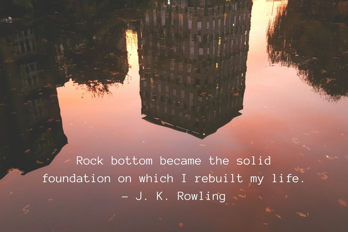 Image of pink sky and buildings reflecting in a canal. Text overlay reads: 'Rock bottom became the solid foundation on which I rebuilt my life. -J. K. Rowling"