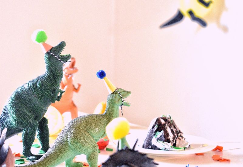 Dinosaurs throwing a 21st birthday party