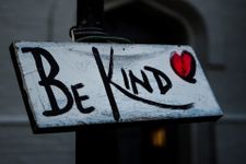 Hand painted sign that says "be kind"