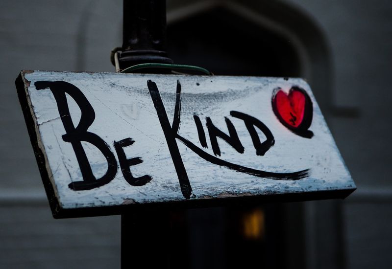 Hand painted sign that says "be kind"