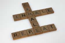 Scrabble letters arranged to say "inhale, exhale, repeat"