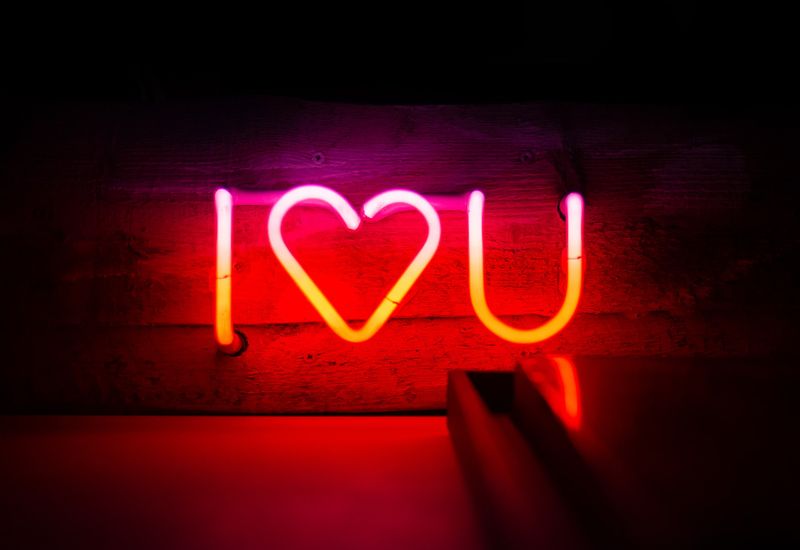 Neon sign that reads "I love you" where the love is represented by a heart