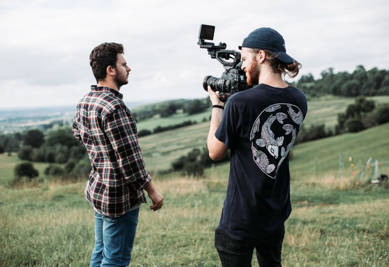 Man stood in front of cameraman in the countryside