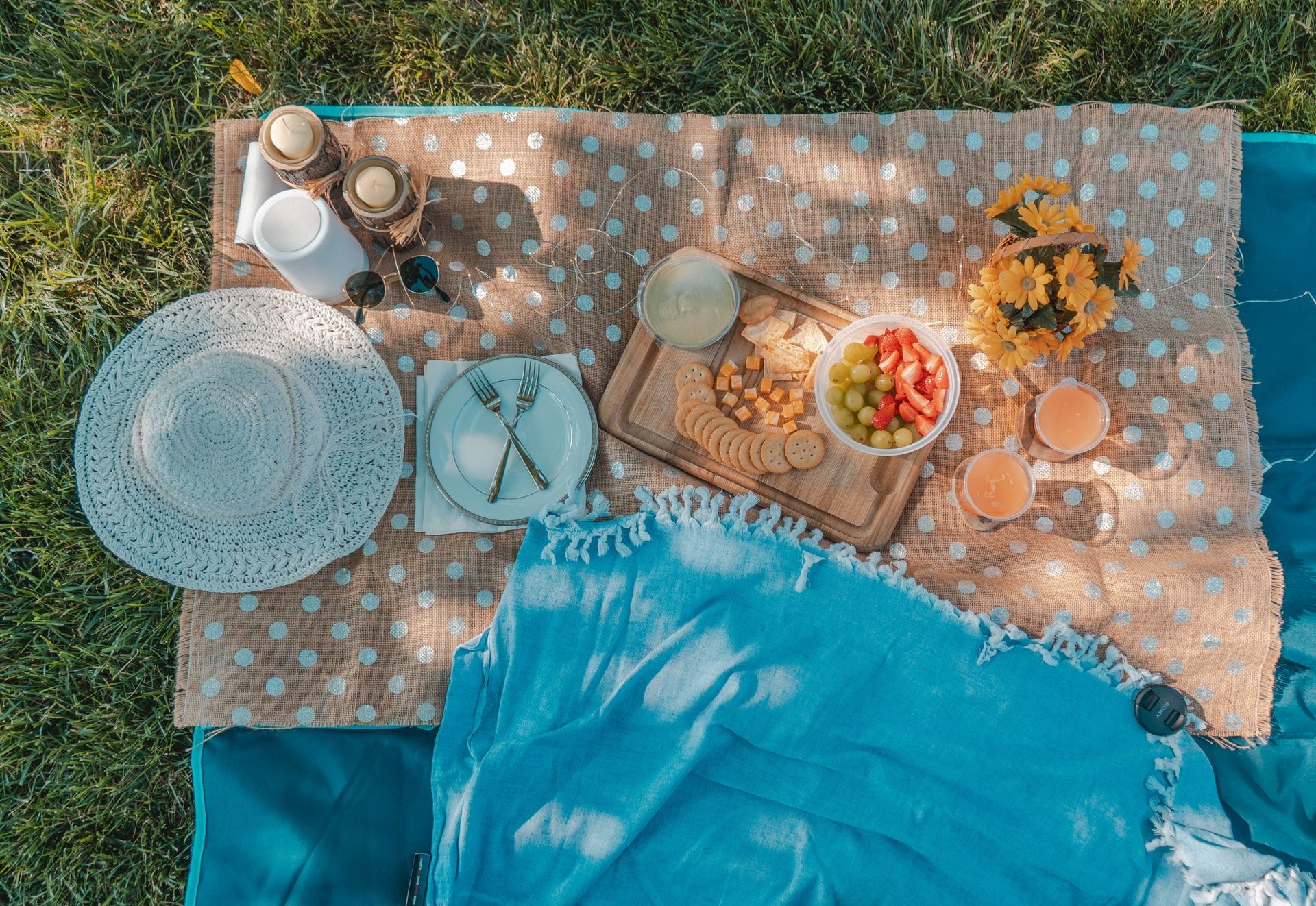 plates and food set out on a picnic blanket