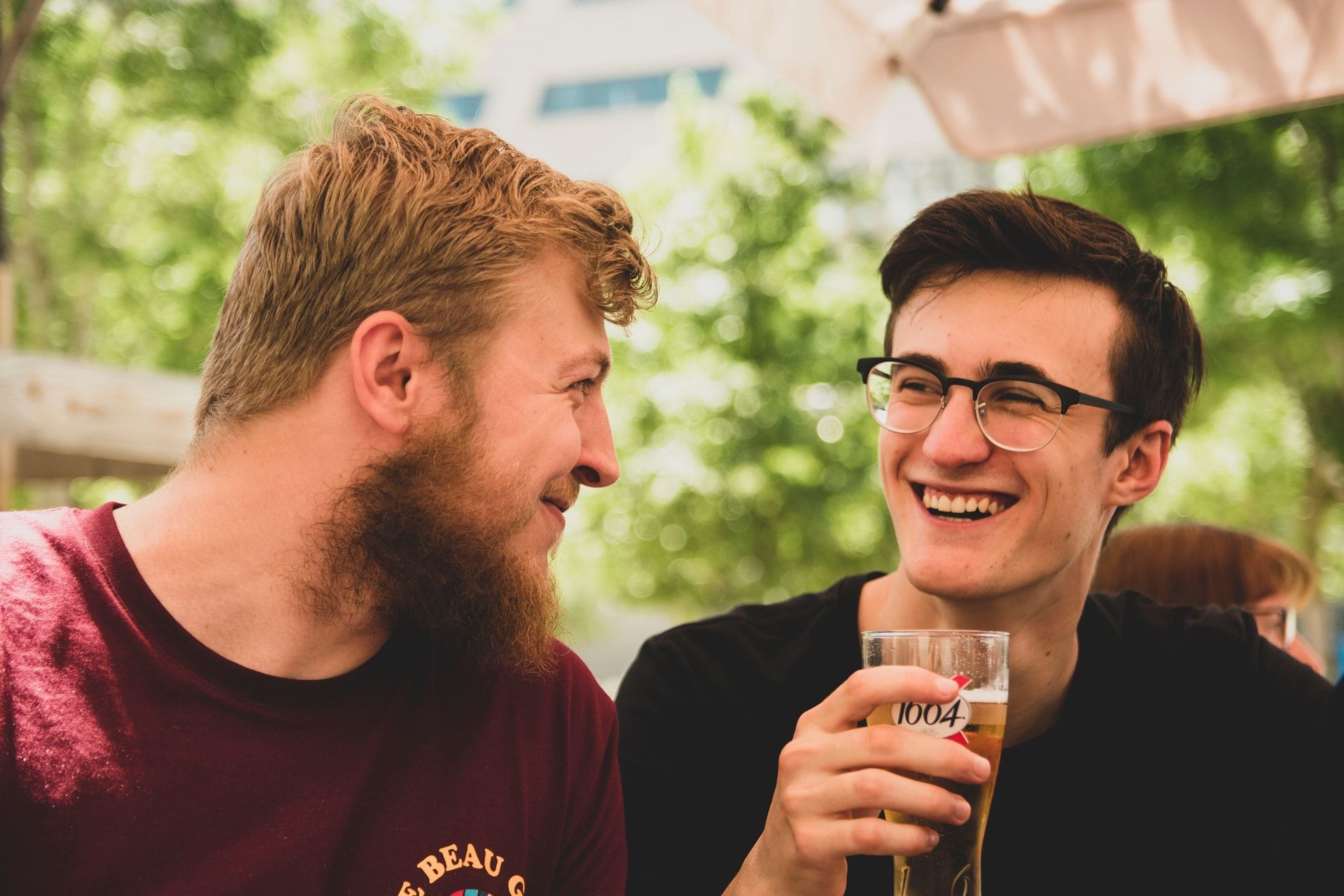 Two young men talking over a beer.