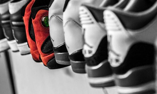Nike Jordan shoes lined up on a rack. 