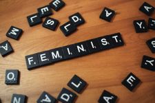 Scrabble tiles arranged to say "feminist"