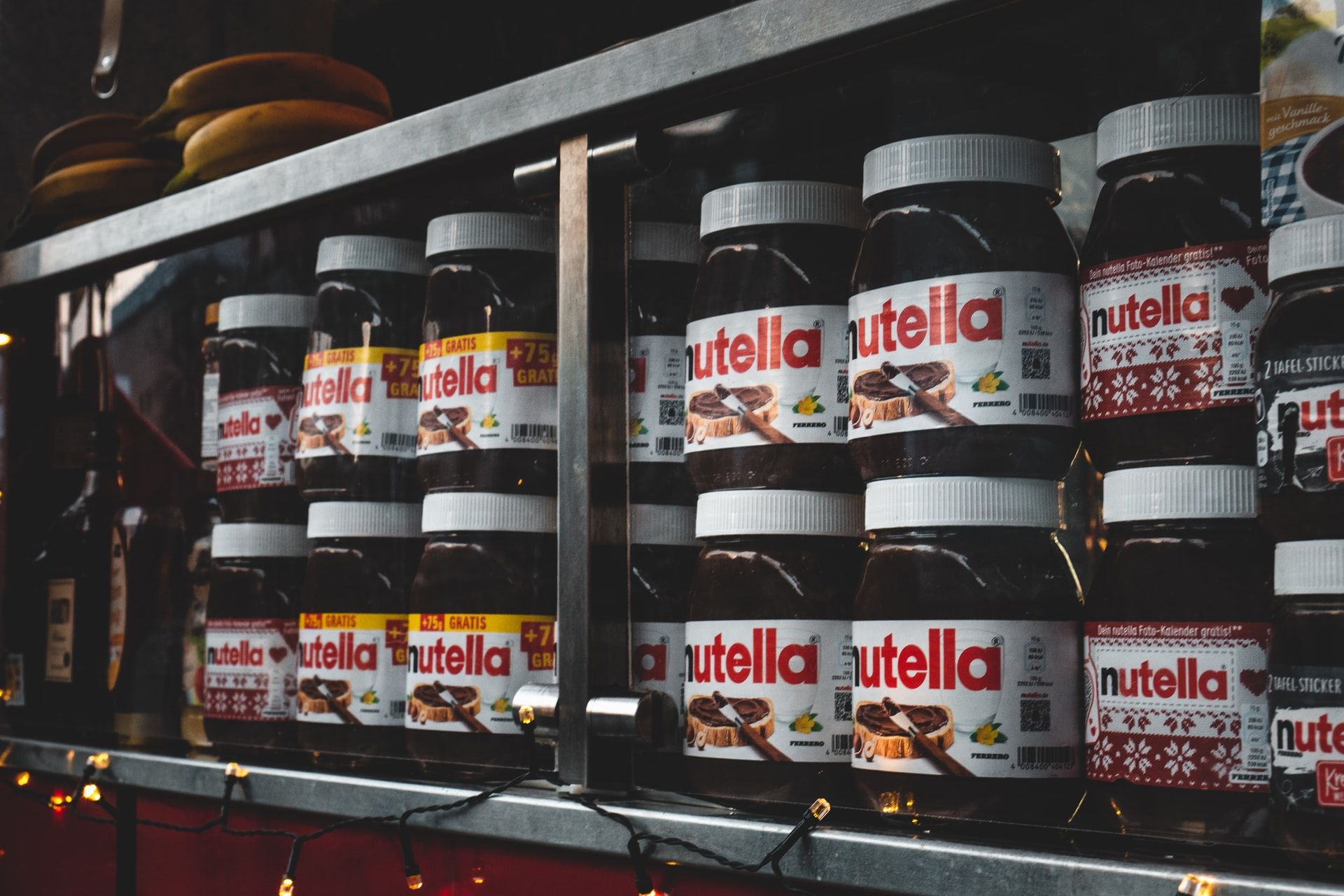 A shelf stacked with jars of Nutella