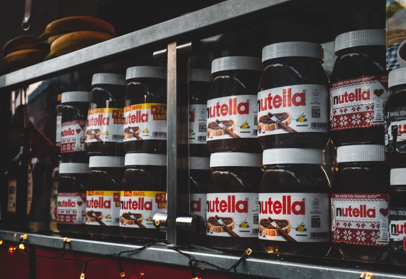 A shelf stacked with jars of Nutella