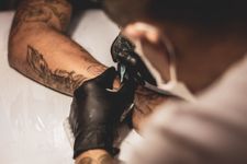 Person receiving a tattoo on their forearm