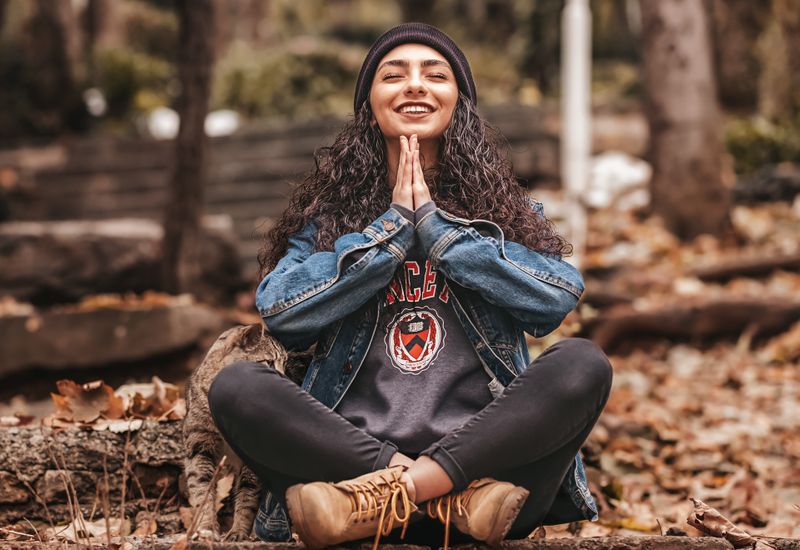Woman meditating in a forest, smiling