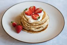 pancakes, strawberries and yoghurt on a plate