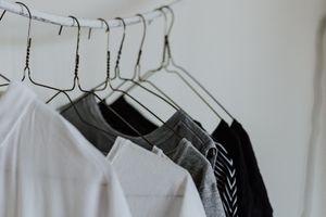 Clothes hanging on a rail.