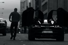 Man walking away from a car in black and white