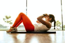 Woman doing a crunch on a yoga mat