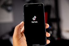 Phone in a hand with the TikTok app opening