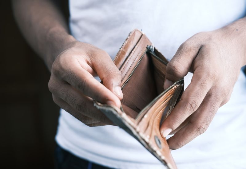 Person holding open an empty wallet