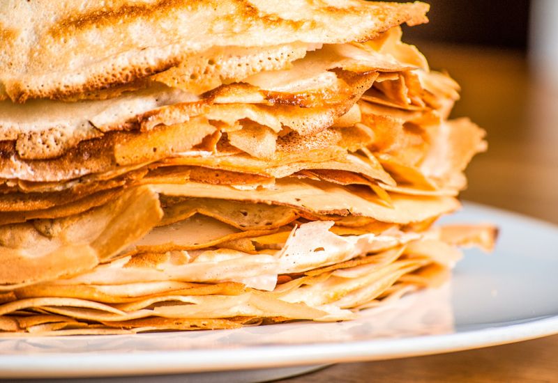 A closeup of a large stack of crispy pancakes